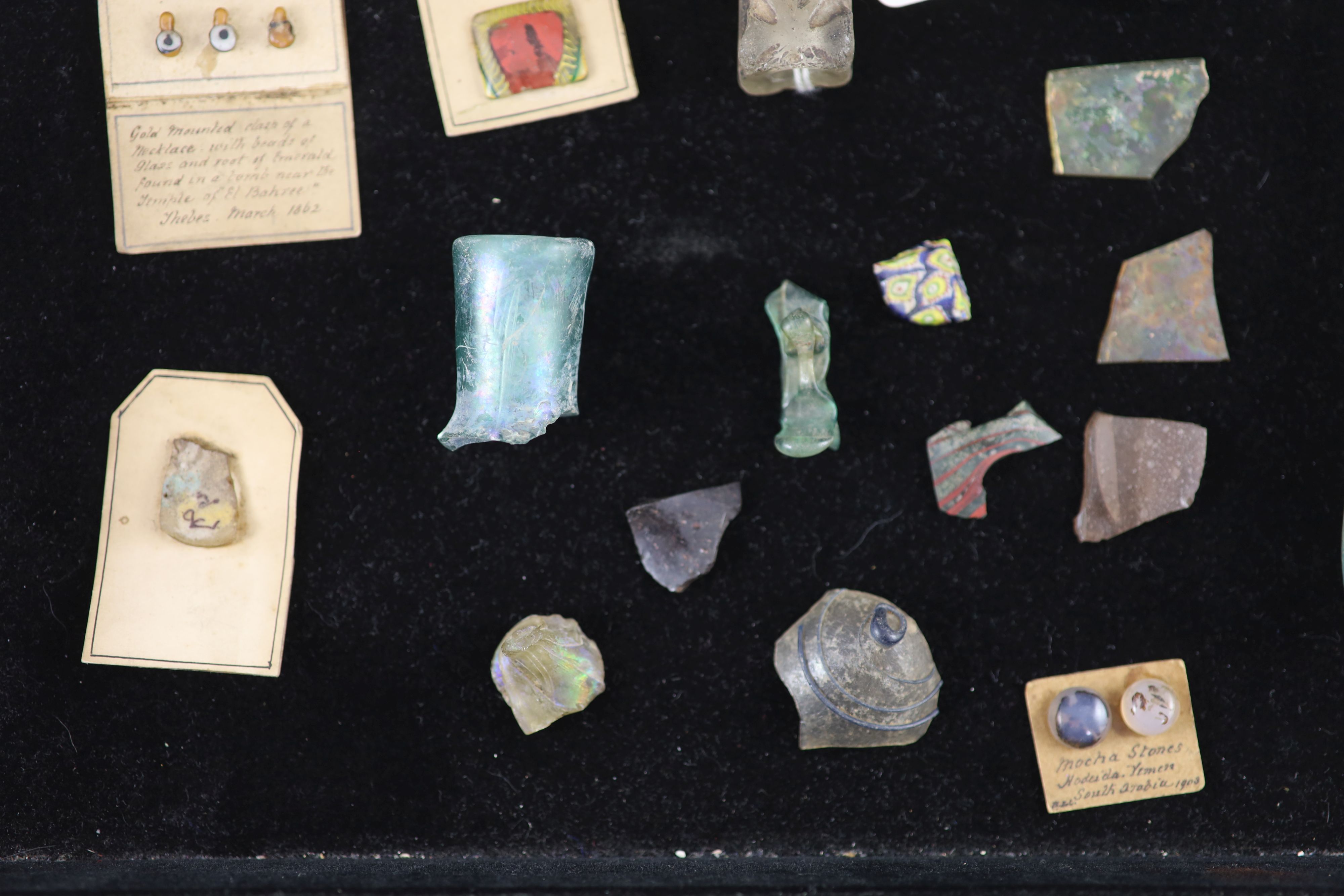 A group of three Roman glass vessels and Egyptian/Roman glass fragments, Provenance - A. T. Arber-Cooke